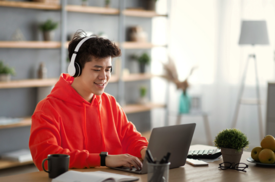 Student on computer headphones